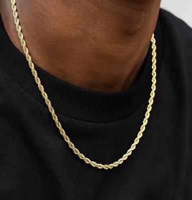 Man wearing a gold rope chain over a black crew-neck shirt